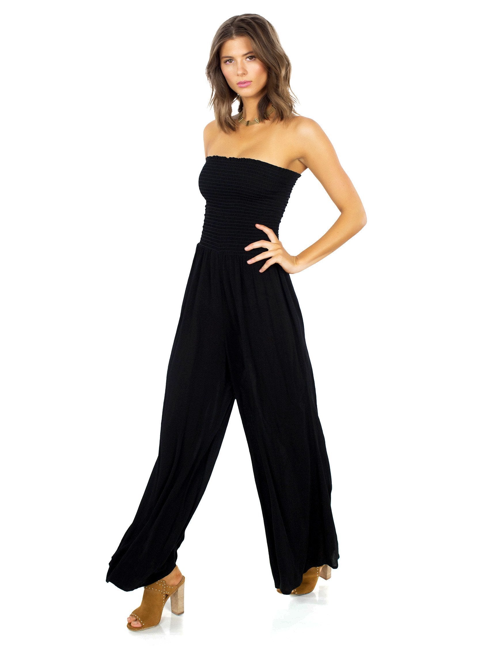 Woman wearing a jumpsuit rental from Blue Life called Smocking Bell Jumper