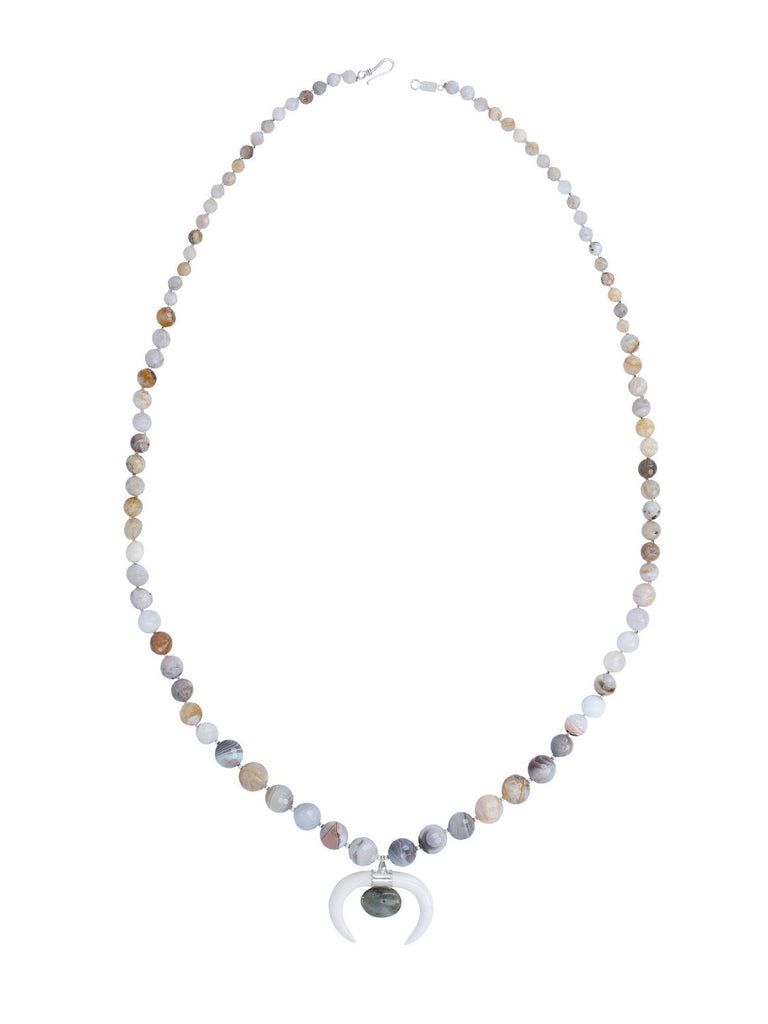 Women wearing a necklace rental from Chan Luu called African Opal Graduated Pendant Necklace