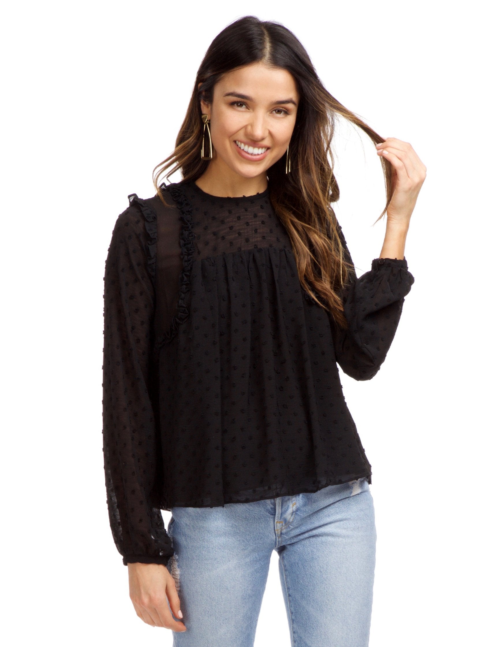 Woman wearing a top rental from Strut & Bolt called Dotted Ruffle Long Sleeve Top