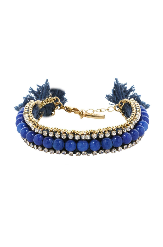 Woman wearing a bracelet rental from Ettika called Crystal Arts Choker In Lapis And Gold
