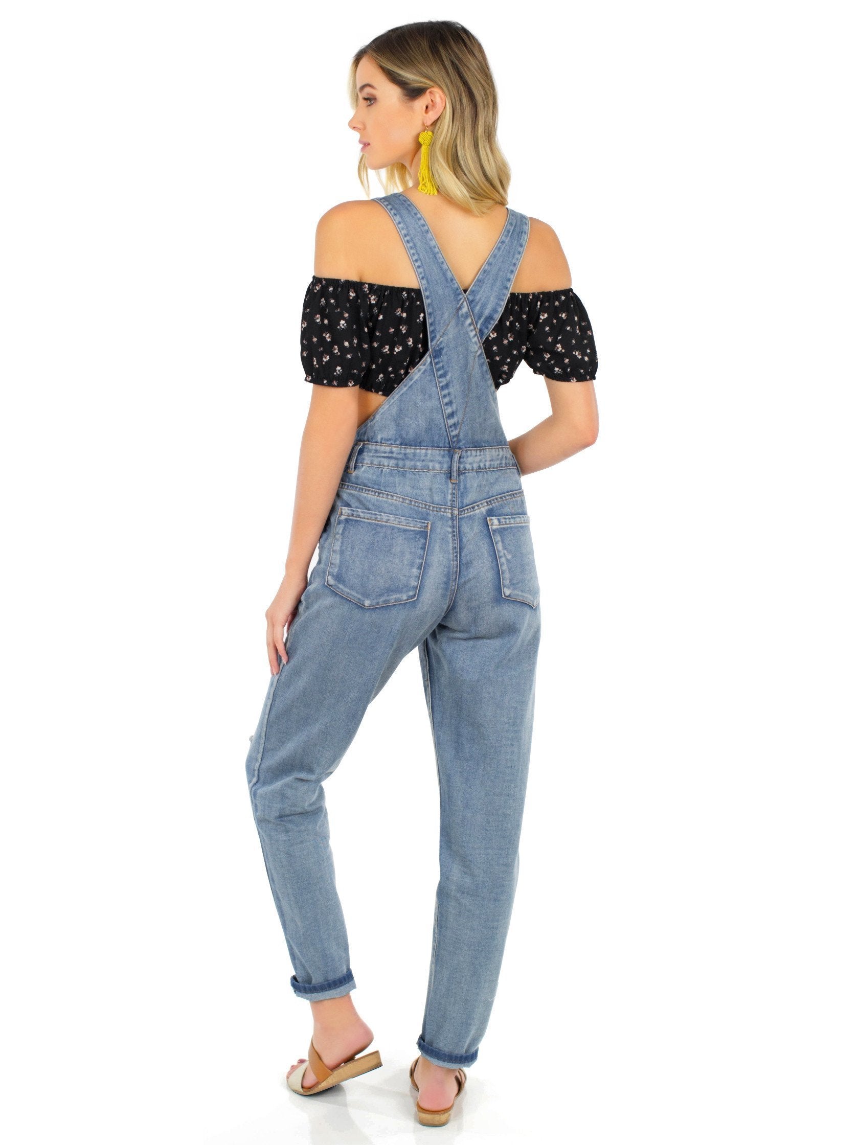 Women wearing a jumpsuit rental from FashionPass called Here For A Good Time Overalls