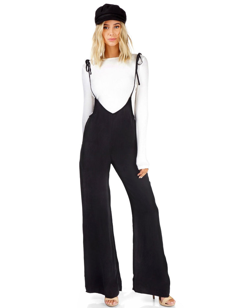 Girl wearing a jumpsuit rental from FashionPass called Harmony Cold Shoulder Sweater