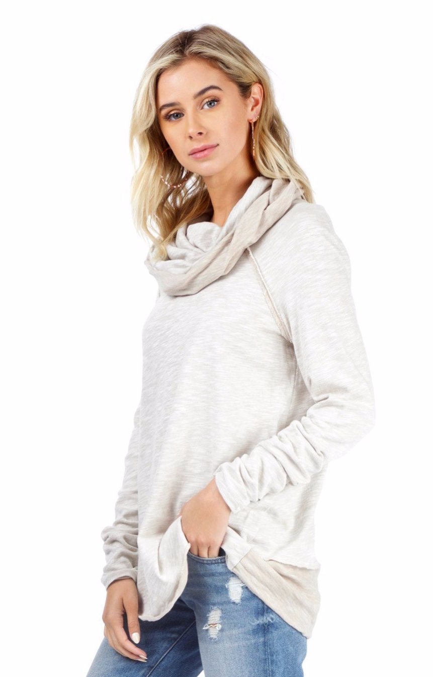 Woman wearing a sweater rental from Free People called Beach Cocoon Cowl Neck Pullover