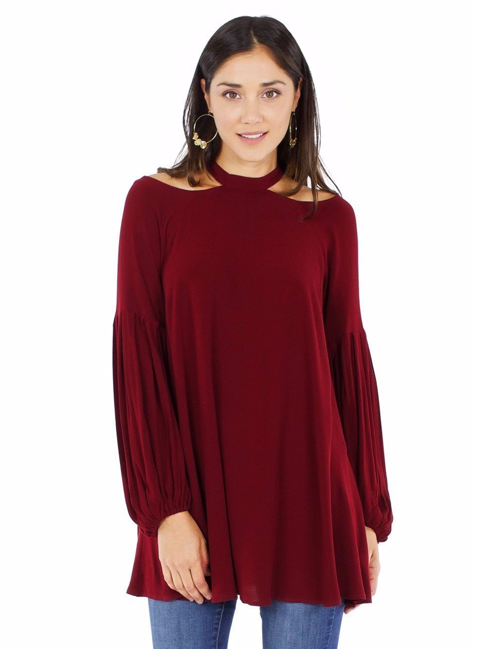 Woman wearing a top rental from Free People called Drift Away Cold Shoulder Tunic