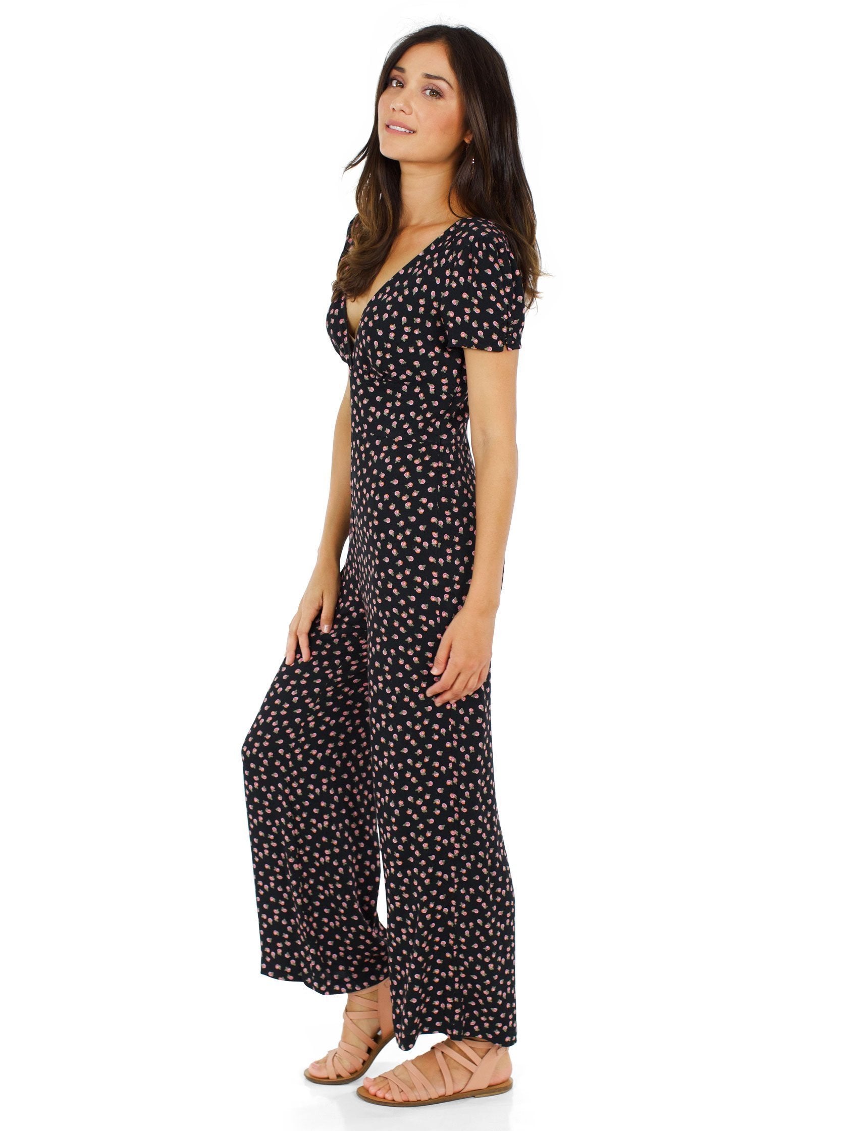 Woman wearing a jumpsuit rental from Free People called Mia Jumpsuit