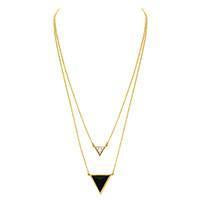 Woman wearing a bracelet rental from House of Harlow 1960 called Classic Station Pyramid Necklace