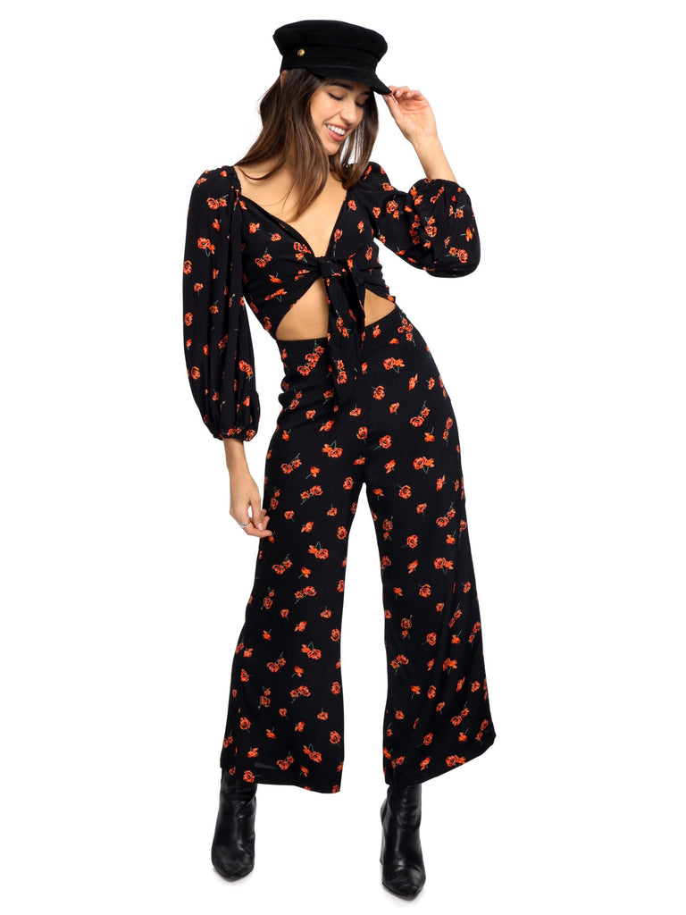 Woman wearing a jumpsuit rental from Blue Life called Sasha Star Print Jumpsuit