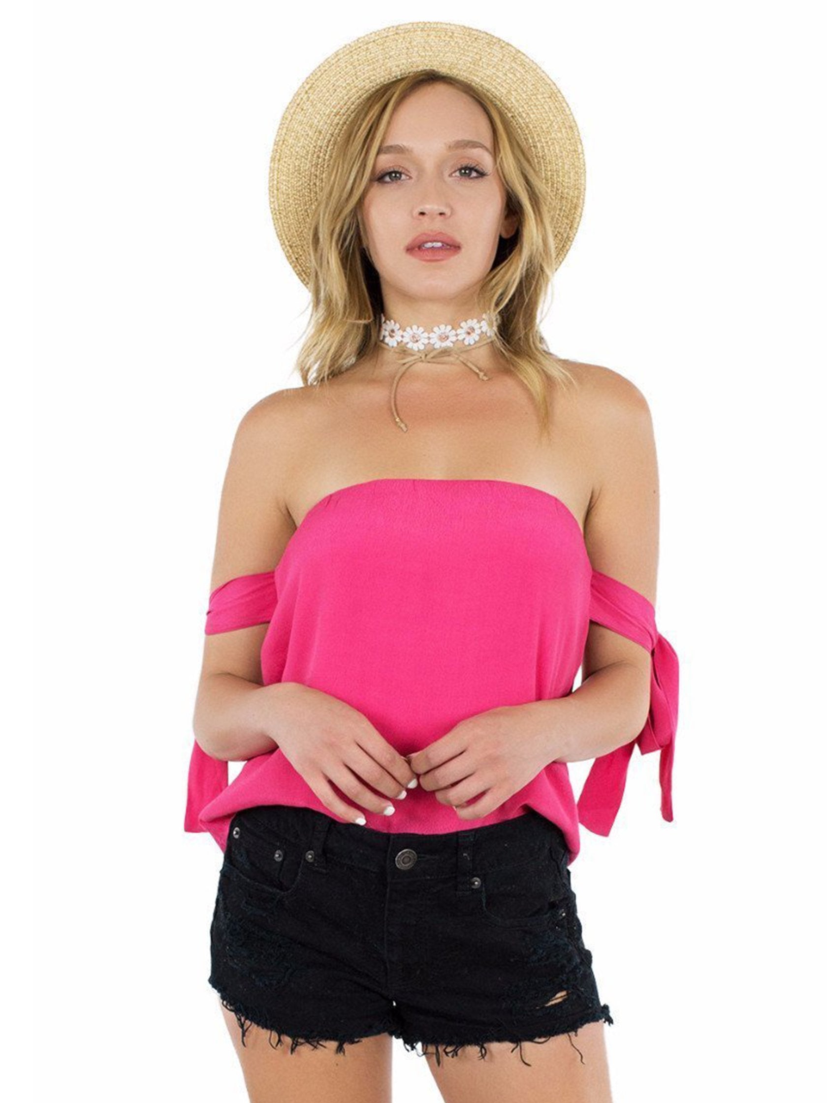 Woman wearing a top rental from Lucca Couture called Guava Off Shoulder Tie Sleeve Top