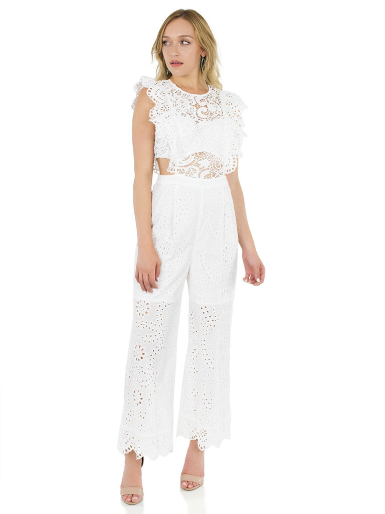Woman wearing a jumpsuit rental from Nightcap Clothing called Sierra Lace Dress