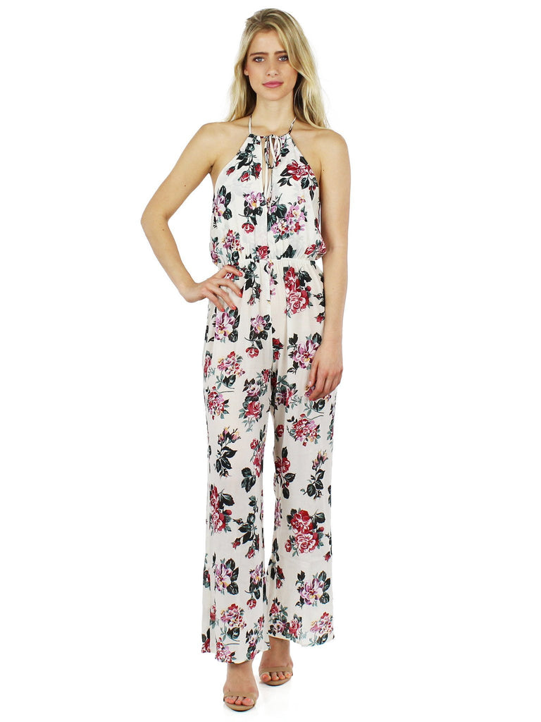 Woman wearing a jumpsuit rental from roe + may called Island Fever Romper