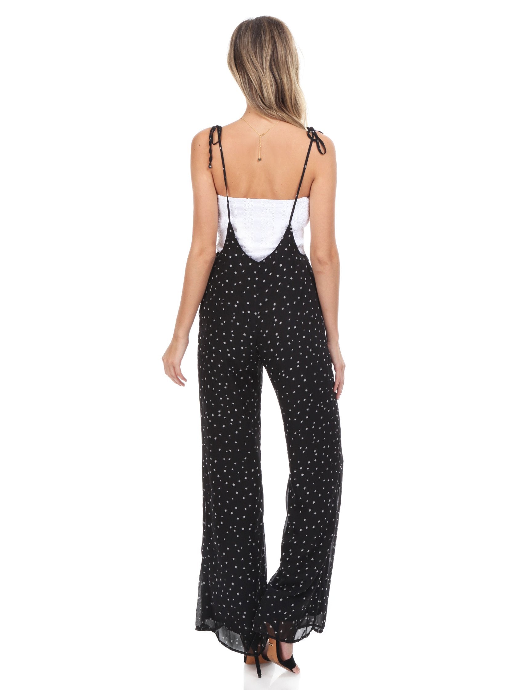 Women wearing a jumpsuit rental from FashionPass called Sasha Star Print Jumpsuit