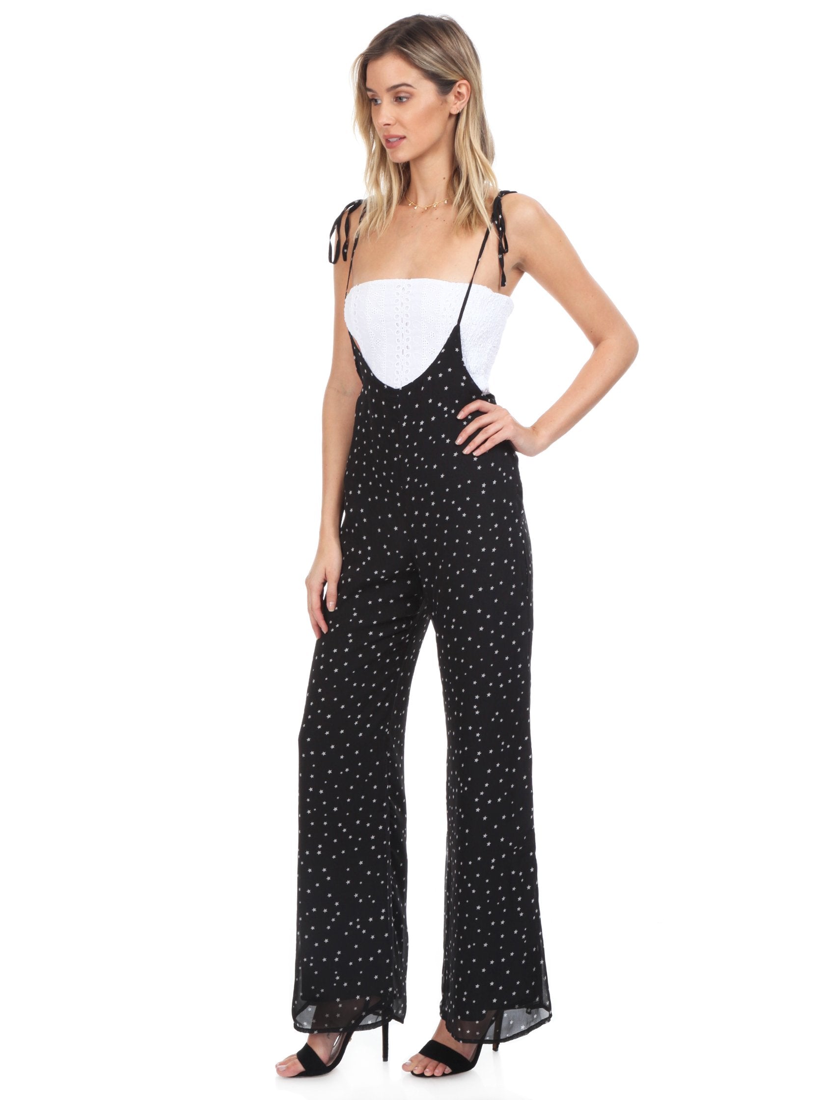 Woman wearing a jumpsuit rental from FashionPass called Sasha Star Print Jumpsuit