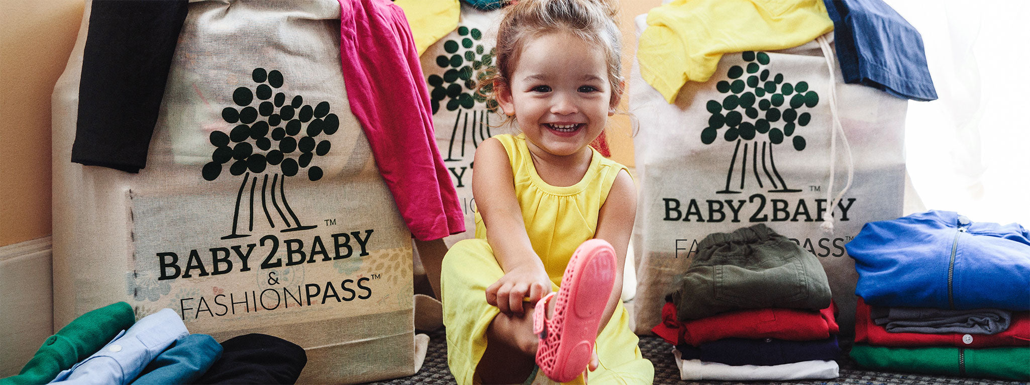 Girl wearing FashionPass sponsored Baby2Baby clothing dress donation